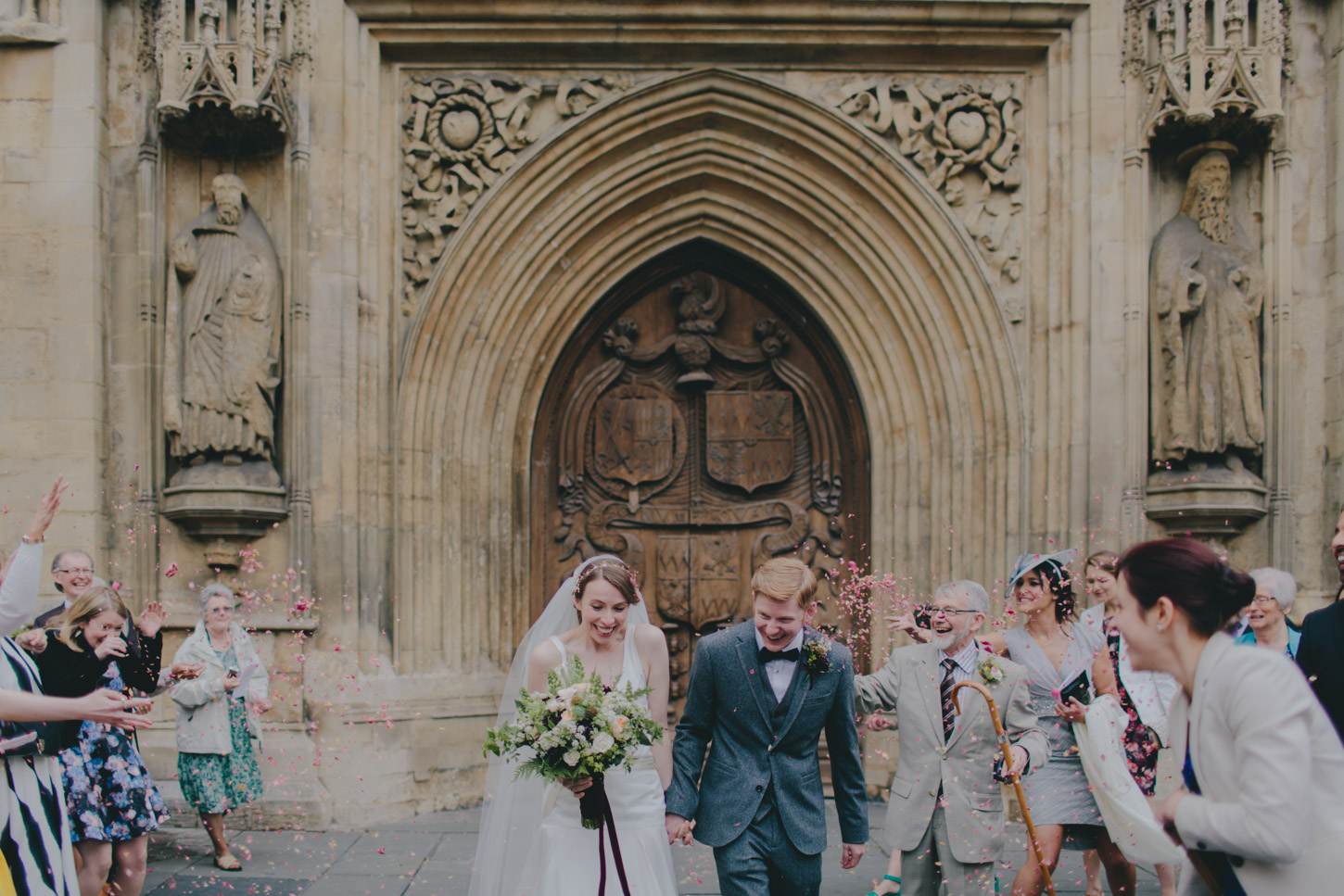 Confetti shot of bride and groom outside of Bath Abbey