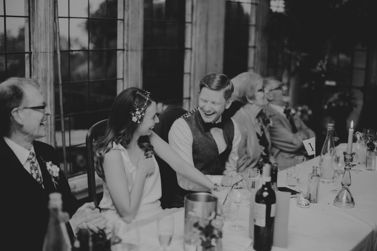 Black and White image of bride and grooms reaction during speeches